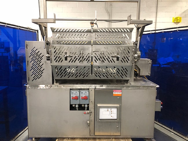 Piece of industrial equipment in a manufacturing plant before custom machine guarding has been installed for employee safety