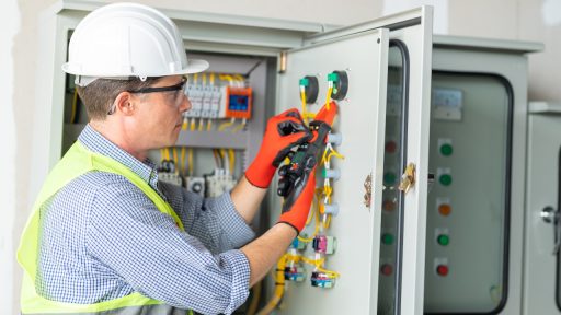 A technician for a panel builder with UL 508A certification tests a UL 508A Listed industrial control panel